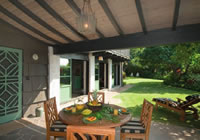 Dining area on sheltered outdoor veranda at Makalei Place house.