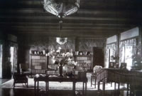 Great room of nearly century old home features 11 foot high ceiling, working fireplace and wall constructed with bluestone