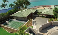 Aerial view of property showing sport court, garage, and rooftop lanai.